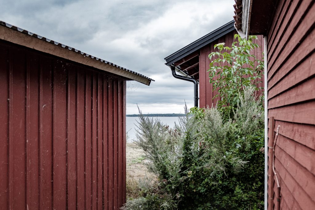 Wide shot of red metal small houses at the coast of the sea